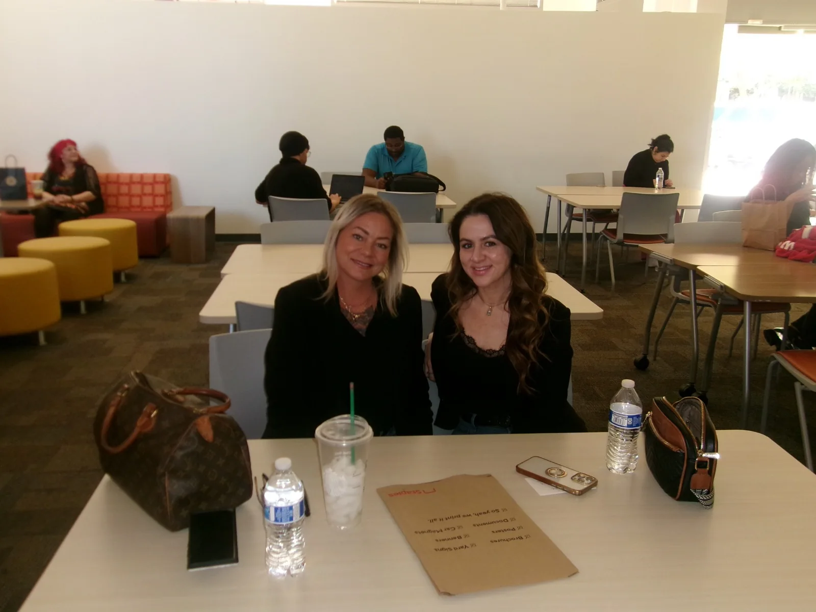 Two attendees seated together at a past AMI event